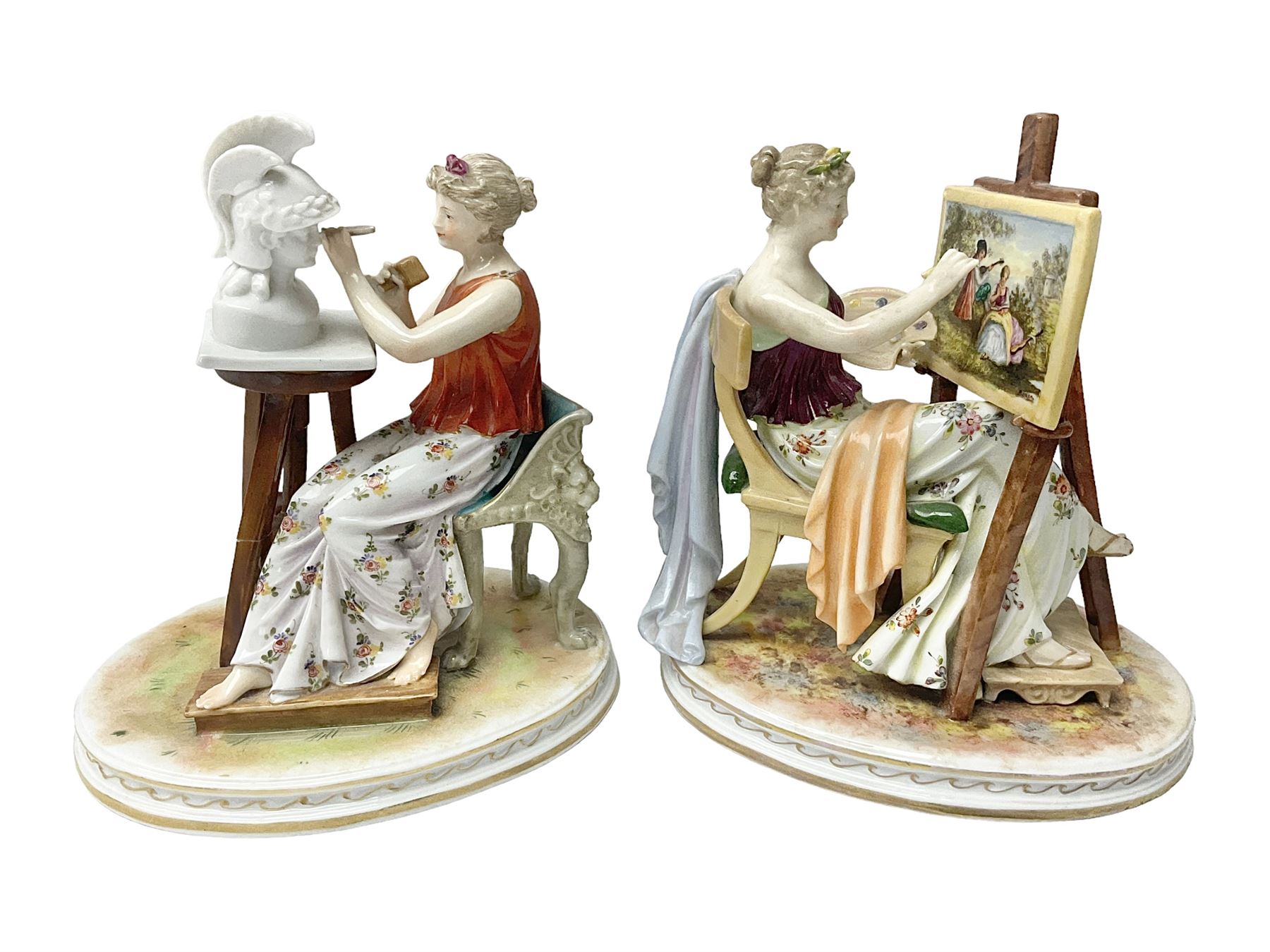 Pair of late 19th/early 20th century Naples figures modelled engaged in the arts, the first example modelled as a female figure seated before an easel, painting a figural scene, the second modelled as a female figure seated before a bust with scultping tools in hand, each upon an oval base with naturalistic painted ground, each with blue crowned N mark beneath, each approximately H16cm, including base L15xm
