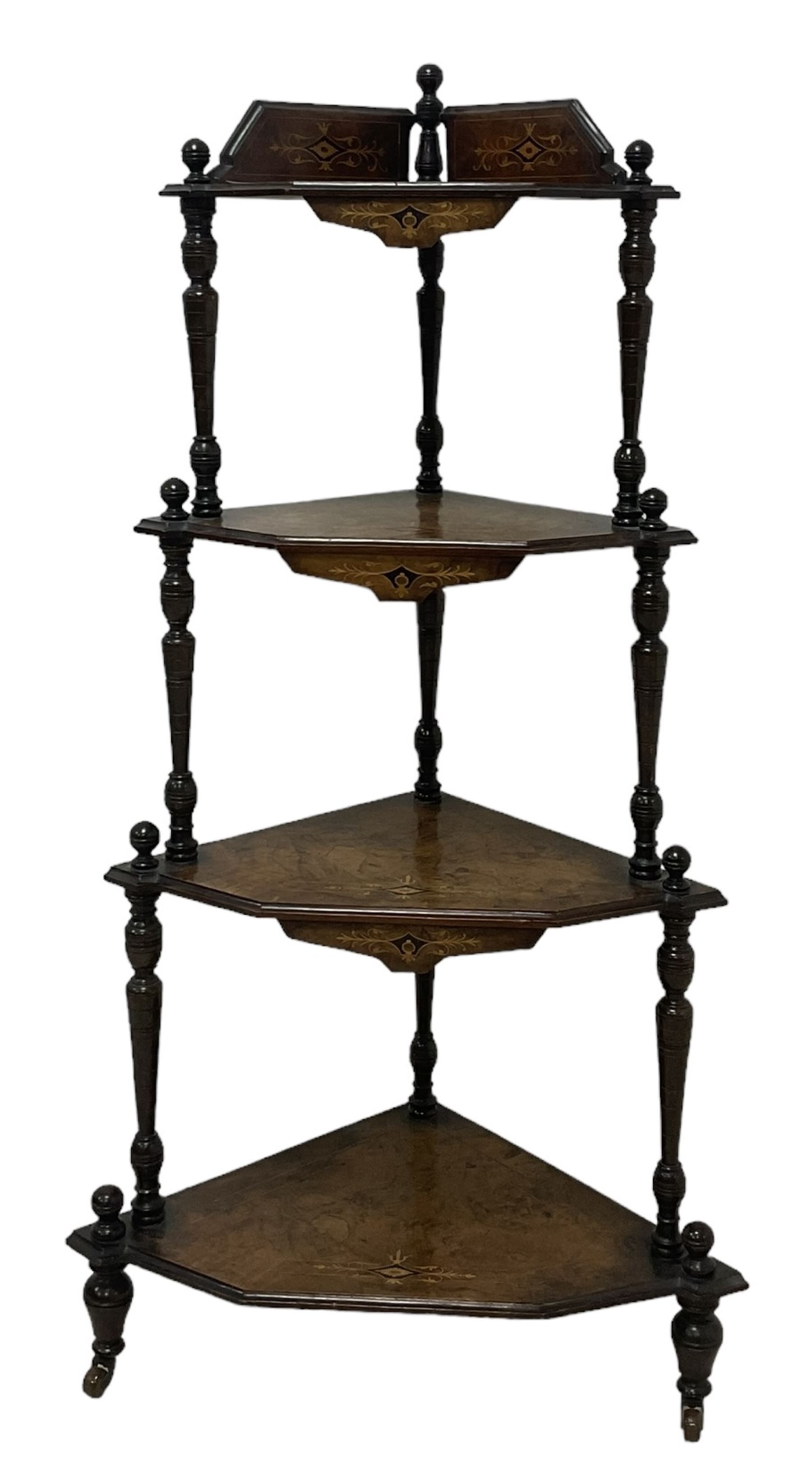 Victorian inlaid walnut corner four-tier whatnot, raised back over four graduating tiers of triangular form, decorated with satinwood and ebony inlays, united by tapering ring turned uprights, on castors