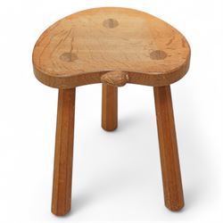 Rabbitman -  oak milking stool, dished kidney shaped top, three tapered octagonal supports, carved with rabbit signature, by Peter Heap, Wetwang