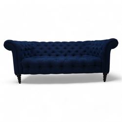 Chesterfield two-seat sofa, traditional shape with rolled arms, upholstered in deep blue buttoned fabric, on black finish turned front feet 