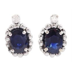 Pair of 14ct white gold oval cut sapphire and round brilliant cut diamond stud earrings