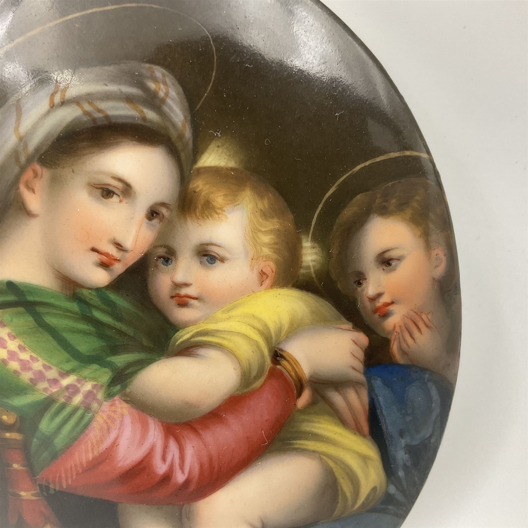 19th century Continental porcelain plaque, of oval form, painted with the Madonna and Child after Raphael, unmarked, possibly KPM, H12cm W9cm 