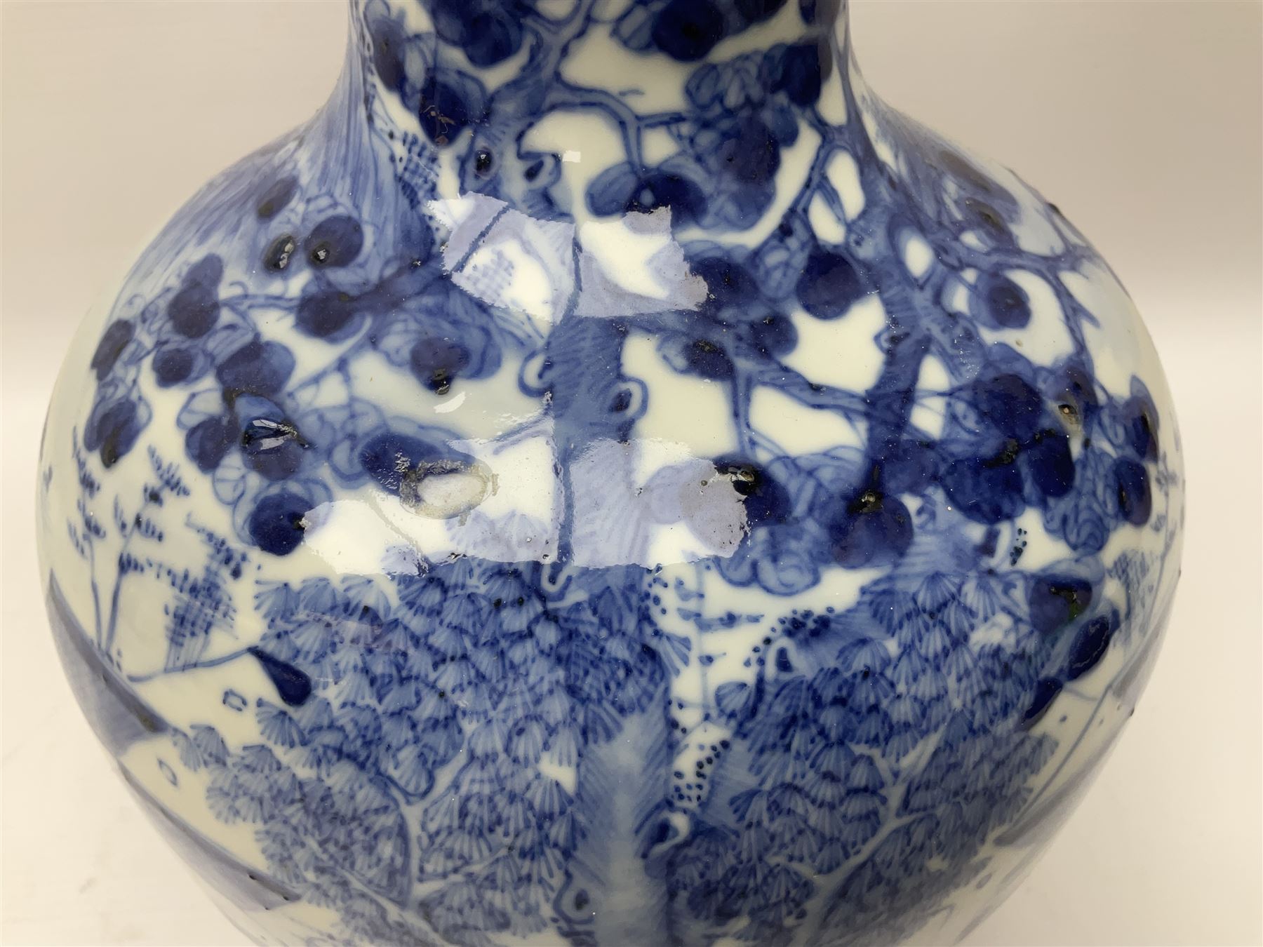 Late 18th/early 19th century Chinese blue and white bottle vase, decorated with a landscape scene containing dwellings, prunus and pine trees, boats and bridges, and populated with figures, with character mark beneath, H35cm