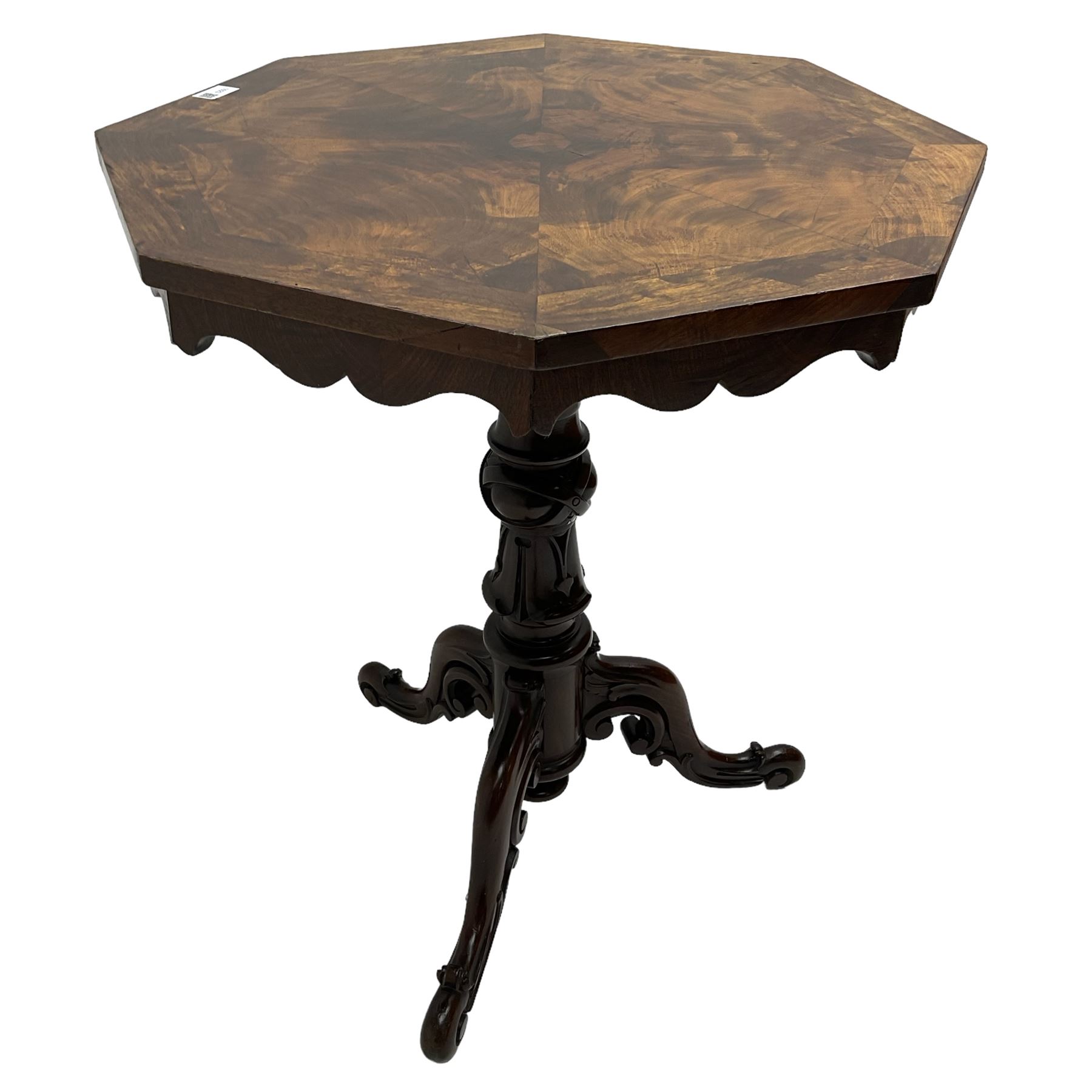 Victorian figured mahogany tripod table, octagonal top with segmented highly figured veneers over pointed arch frieze rails, on turned egg and dart carved pedestal with lappet carved baluster, three splayed and C-scroll carved supports with scrolled terminals