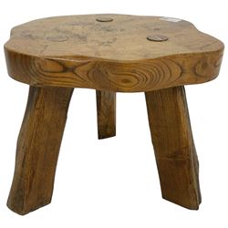 Small rustic elm three-legged stool, with metal plaque to the underneath inscribed 'Wandewood' 