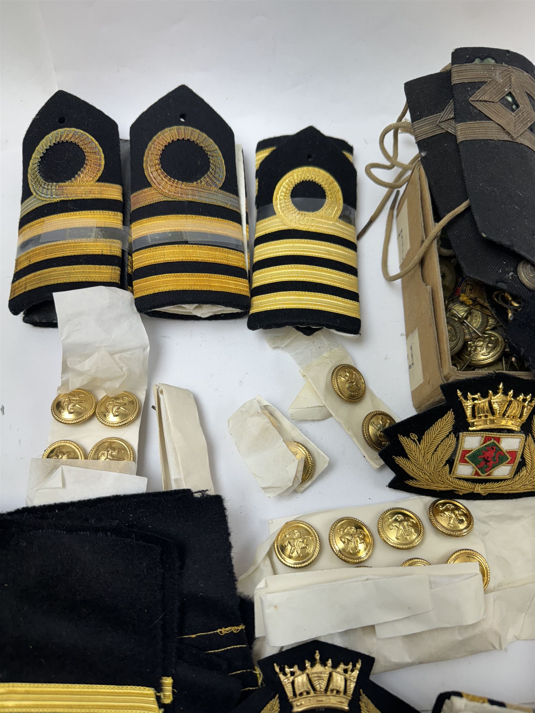 Royal Navy Lieutenant's Frock Coat by Haycock and Jarman, together with other naval accessories, including four pairs of Captain's insignia, six pairs of Captain's shoulder boards, a Merchant Navy cap badge and a collection of other badges, buttons and shoulder boards 