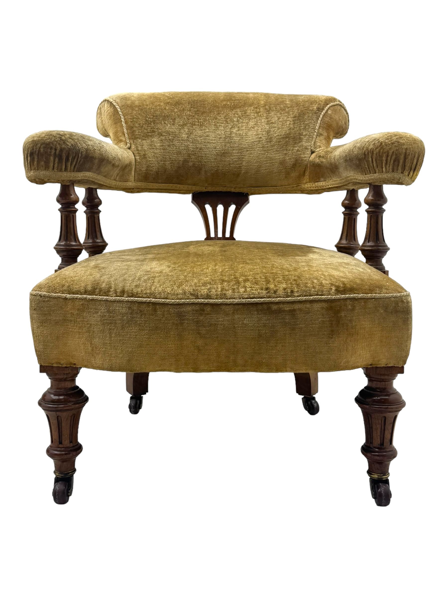 Victorian pair of mahogany armchairs, upholstered in gold velvet fabric, each with curved back, pierced splat and scroll arms, one with rounded seat and the other square, on turned front supports with castors