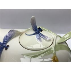 Franz Teapot decorated with dragonflies, together with a matching sucrier and cover and a cup and saucer in Iris pattern, all with printed mark beneath 