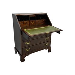 Mid-to-late 20th century inlaid mahogany bureau, inlaid floral medallion to the top, the fall front opening to reveal fitted interior with pigeonholes, small drawers and central cupboard, green inset writing surface with gilt tooling, four drawers below with brass handles, raised on shaped bracket feet