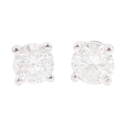 Pair of 18ct white gold round brilliant cut diamond stud earrings, stamped, total diamond ...