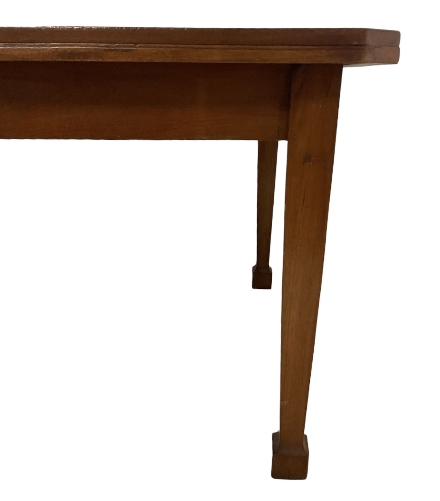 Mid-to-late 20th century teak dining table, rectangular top with canted corners, on square tapering supports with spade feet (214cm x 119cm, H76cm); and a set of eight Burmese reclaimed teak dining chairs, high arched back over panelled seat