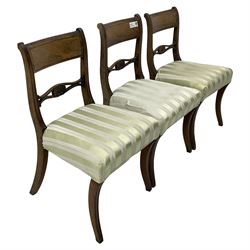 Set of six early 19th century mahogany dining chairs, bar cresting rail over pierced and shell carved middle rail, reed moulded uprights, upholstered seats on reed moulded sabre supports 