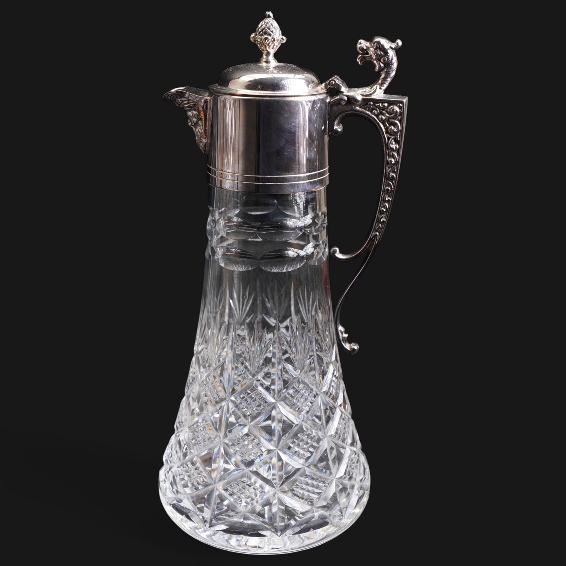 20th century silver-plated bottle coaster with grape vine decoration, cut glass claret jug with silver-plated mounts, H30cm and an early 20th century Elkington silver plate soup tureen, lacking cover 