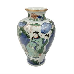 Chinese Wucai vase, of baluster form, decorated with an official and attendants in a garden setting, with crane, fence and rockwork, H19cm