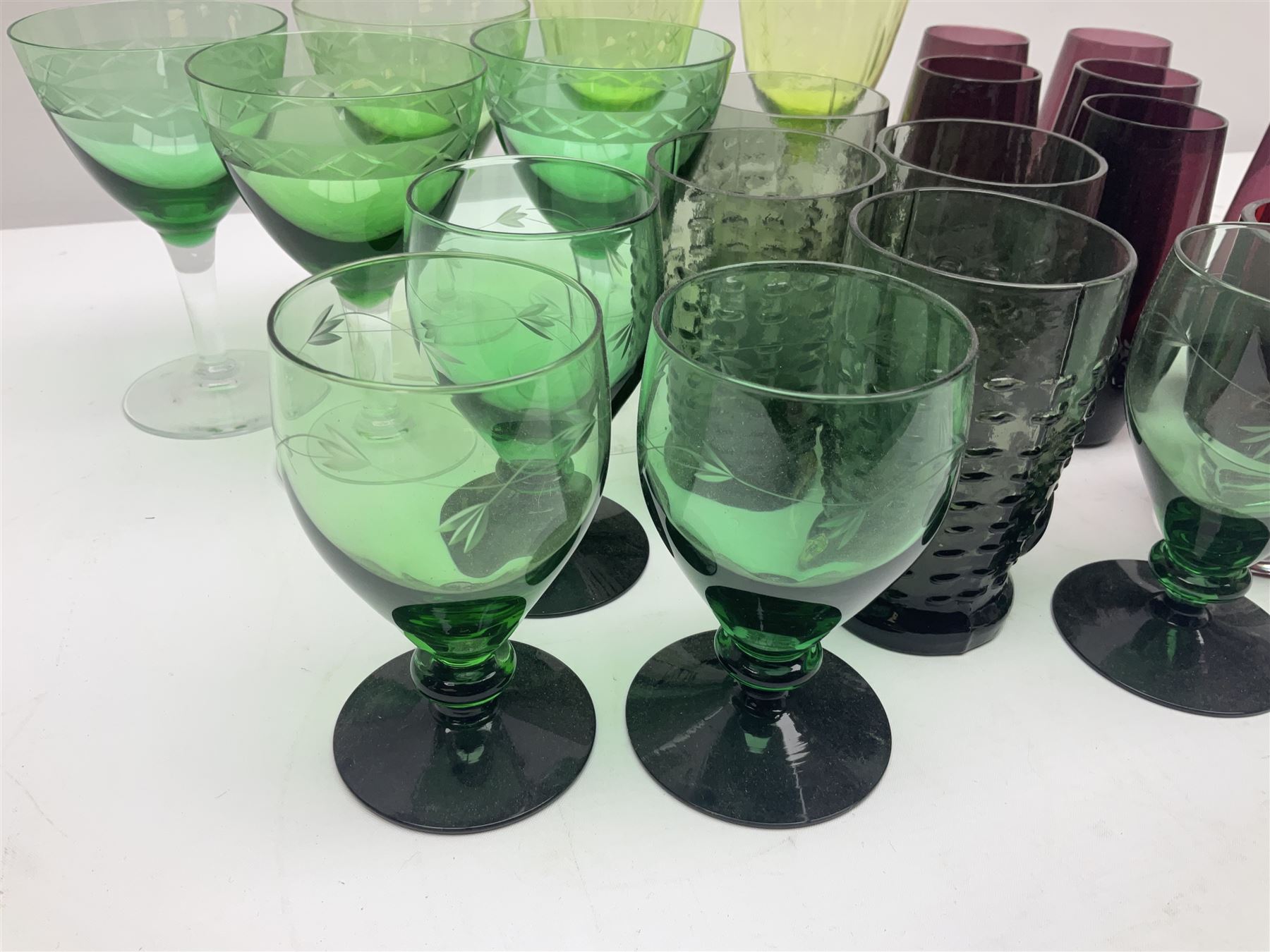 Set of four Swedish Reijmyre drinking glasses, with textured outer surface, together with green drinking glasses including Holmegaard examples and other glassware