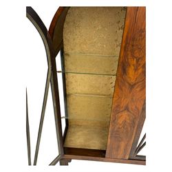 Early 20th century Art Deco walnut display cabinet, with arched top and carved floral crest, central band flanked by two glazed panel doors with decorative mullions, enclosing two glass shelves, on scroll carved bracket feet