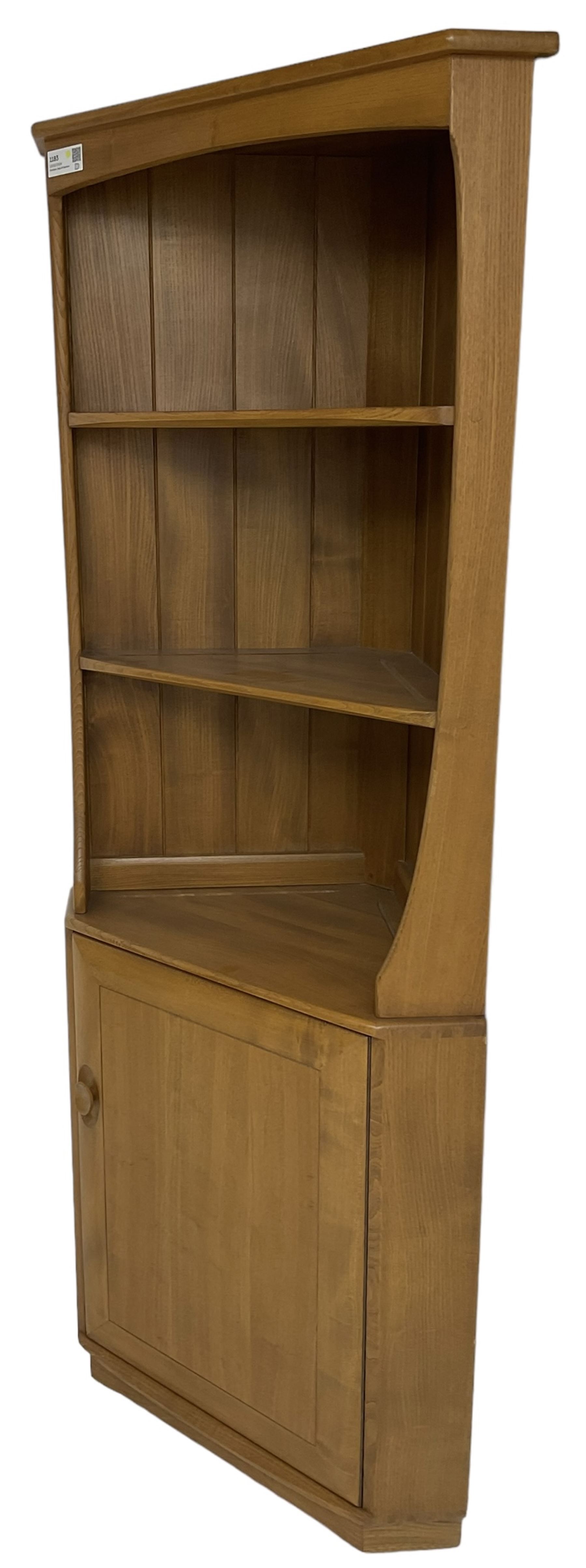 Ercol - mid-20th century '743C'  light elm corner cabinet, fitted with two open shelves over a single cupboard