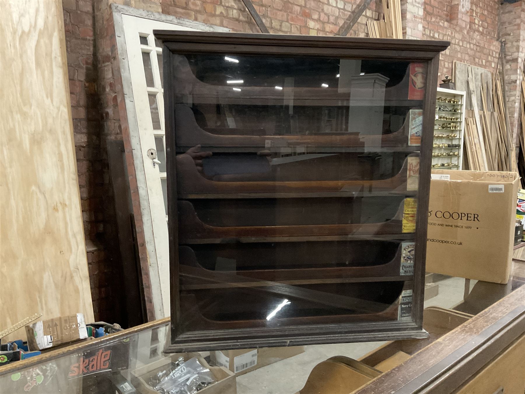 Early 20th stained pine and glazed wall mounting cigarette shop display cabinet, fitted with six sliding drawers with divisions and scalloped handles  - THIS LOT IS TO BE COLLECTED BY APPOINTMENT FROM THE OLD BUFFER DEPOT, MELBOURNE PLACE, SOWERBY, THIRSK, YO7 1QY