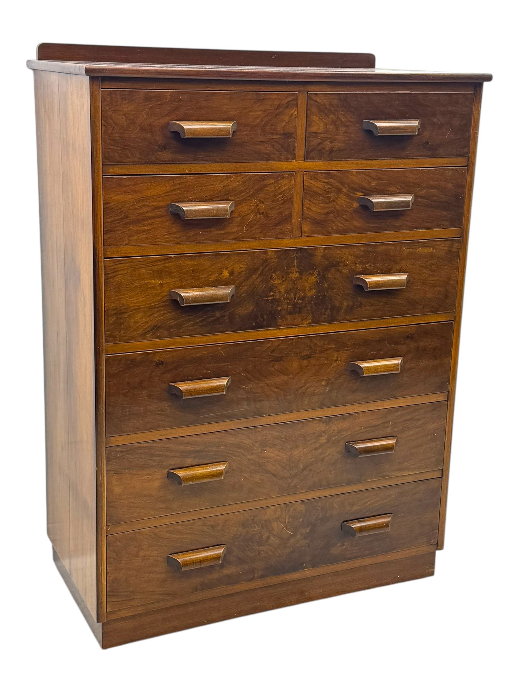 Early 20th century walnut chest, fitted with four short and four long drawers, on recessed plinth base