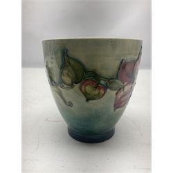Moorcroft vase of tapering form decorated in the Clematis pattern, upon merging blue green ground, together with a small Green Columbine pattern footed bowl, and Hibiscus pattern dish of oval form, all with impressed marks beneath, tallest H9cm (3)