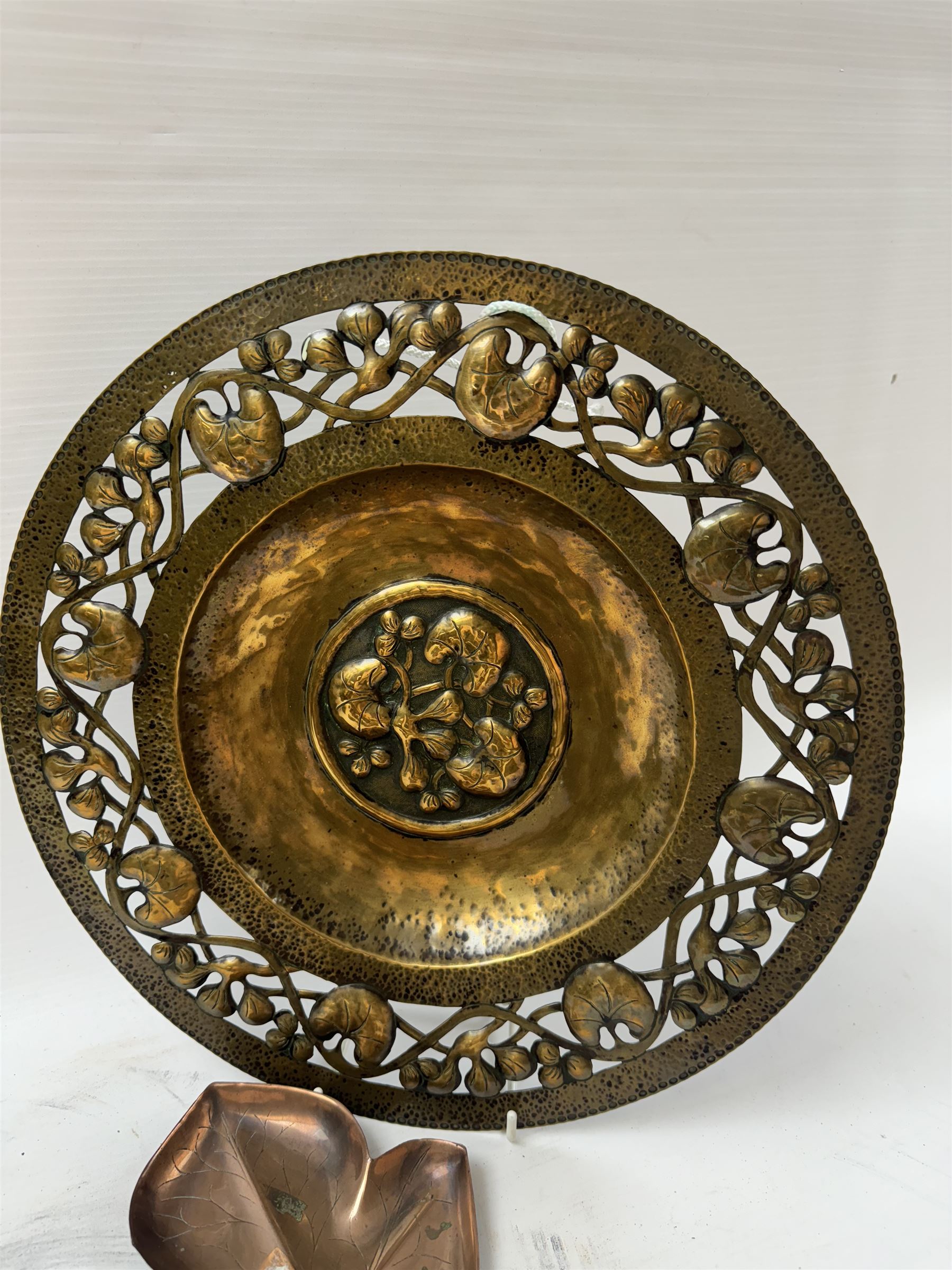 Keswick School of Industrial Arts, flared vase of cylindrical form, together with an Arts and Crafts plated copper, an embossed tray, copper dishes and charger 