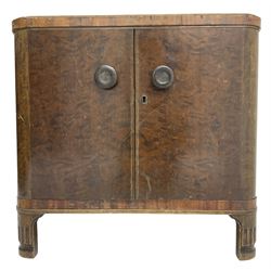 Art Deco period walnut end table, the top inlaid with central shaped panel and extending fan motifs, fitted with two drawers, double cupboard and shelves, on bracket feet