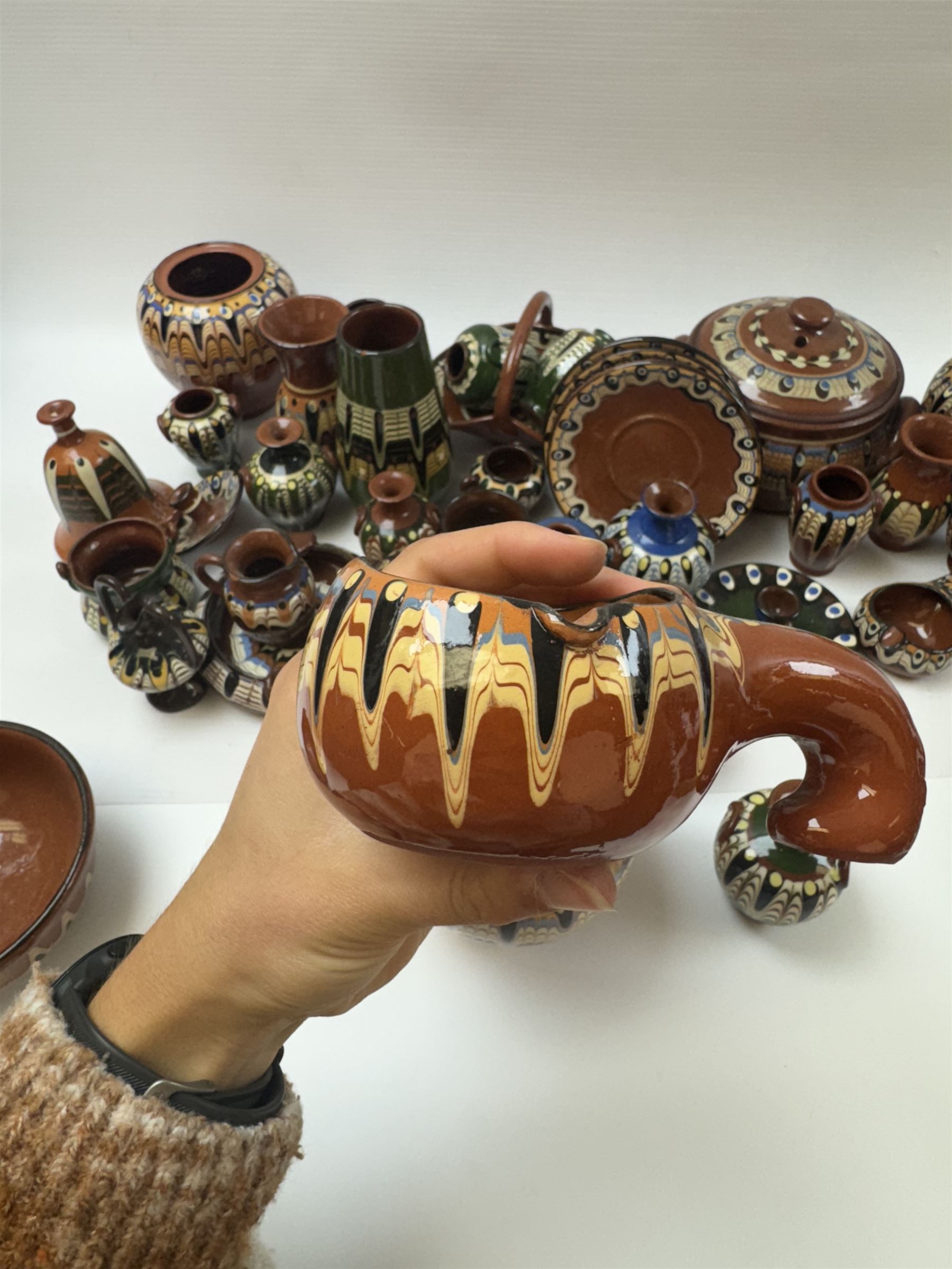 Collection of slipware, including miniature vases, baskets, candlesticks jugs etc 