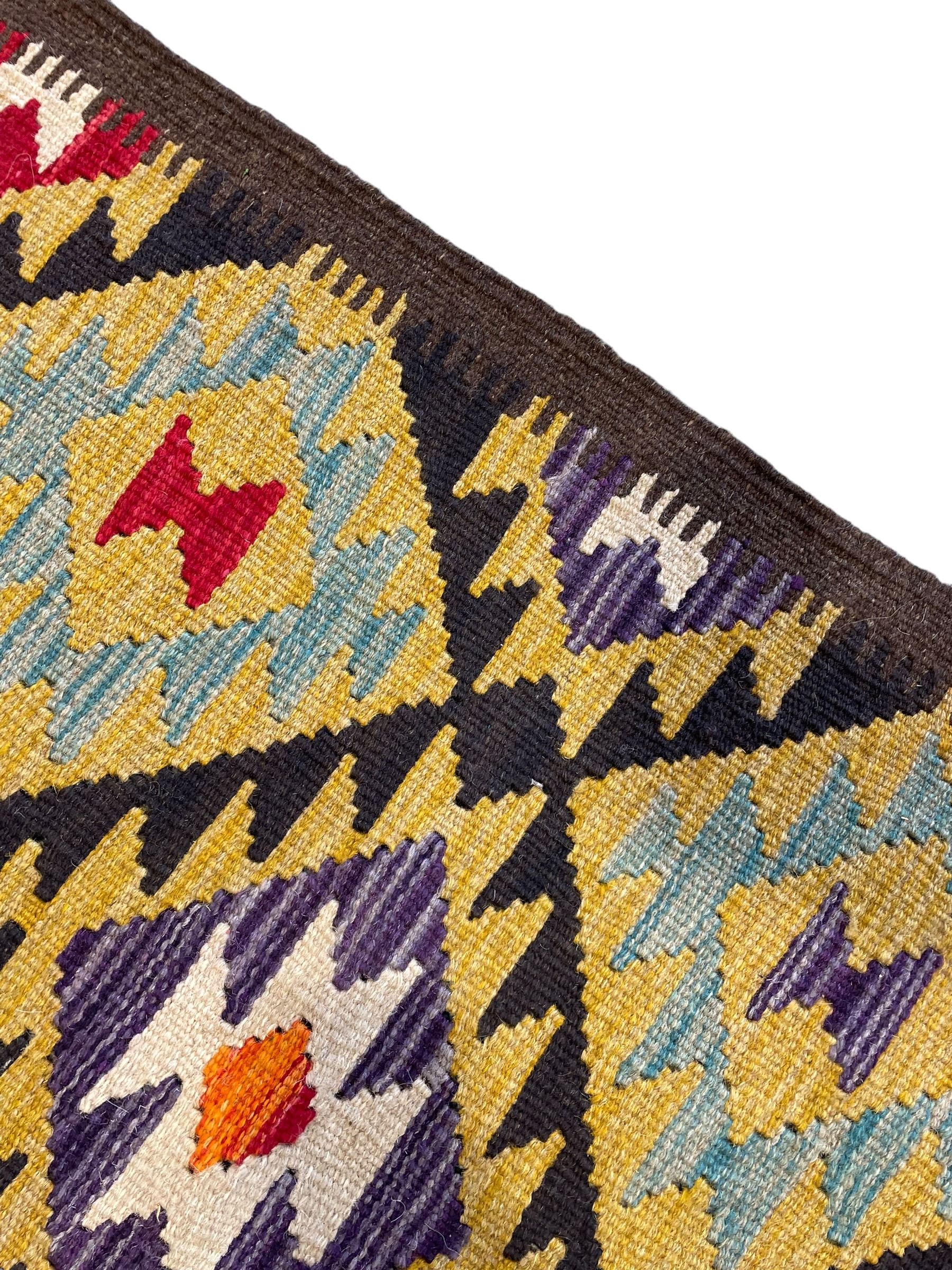 Chobi Kilim multi-colour runner rug, the field decorated with geometric lozenges in contrasting shades on brown ground