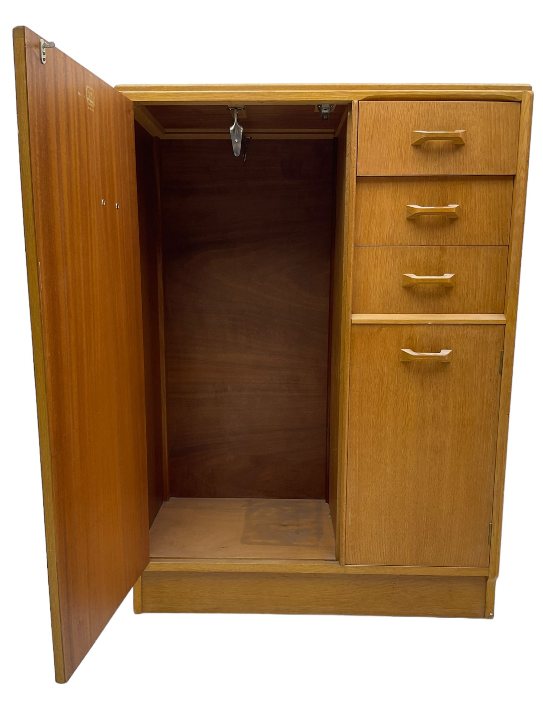 G-Plan - mid 20th century teak tallboy or combination wardrobe, left side with full-height hanging cupboard, right side with three drawers, the top fitted with vanity mirror, above cupboard with shelves, raised on a plinth base