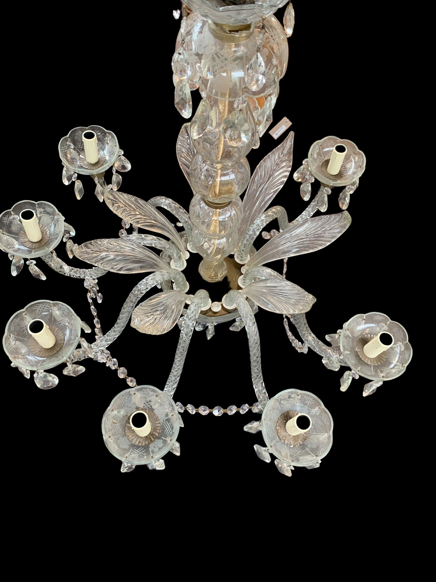 Italian style eight branch glass chandelier, with baluster stem, eight barley twist scroll arms interspersed by seven clear blown glass leaves, petal edged drip pans and hung with faceted glass bead swags and drops, H94cm x W85cm approx.