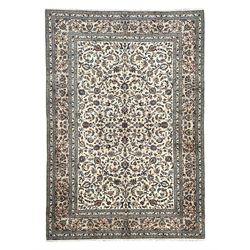 Persian Kashan ivory ground rug, decorated with curled leafy branches and palmettes, the b...