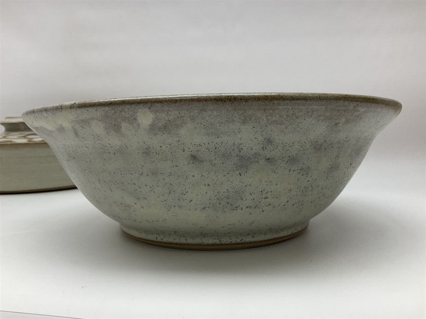 John Egerton (c1945-): studio pottery stoneware, comprising twin shallow covered dish, serving bowl and eight dessert bowls, all decorated with flowering sprigs on a cream ground, dish D28cm