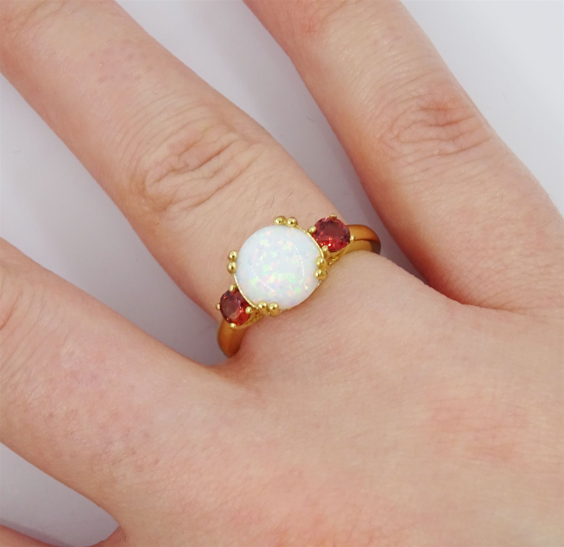 Silver-gilt three stone opal and garnet ring, stamped 925