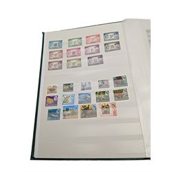 Mostly Commonwealth or Empire stamps including Queen Elizabeth II Northern Rhodesia, Nyasaland, Solomon Islands, Aden, Bermuda, Grenada 'Associated Statehood' overprints, King George VI Falkland Islands Dependencies with values to one shilling etc, mixture of mint and used, housed in a green stockbook