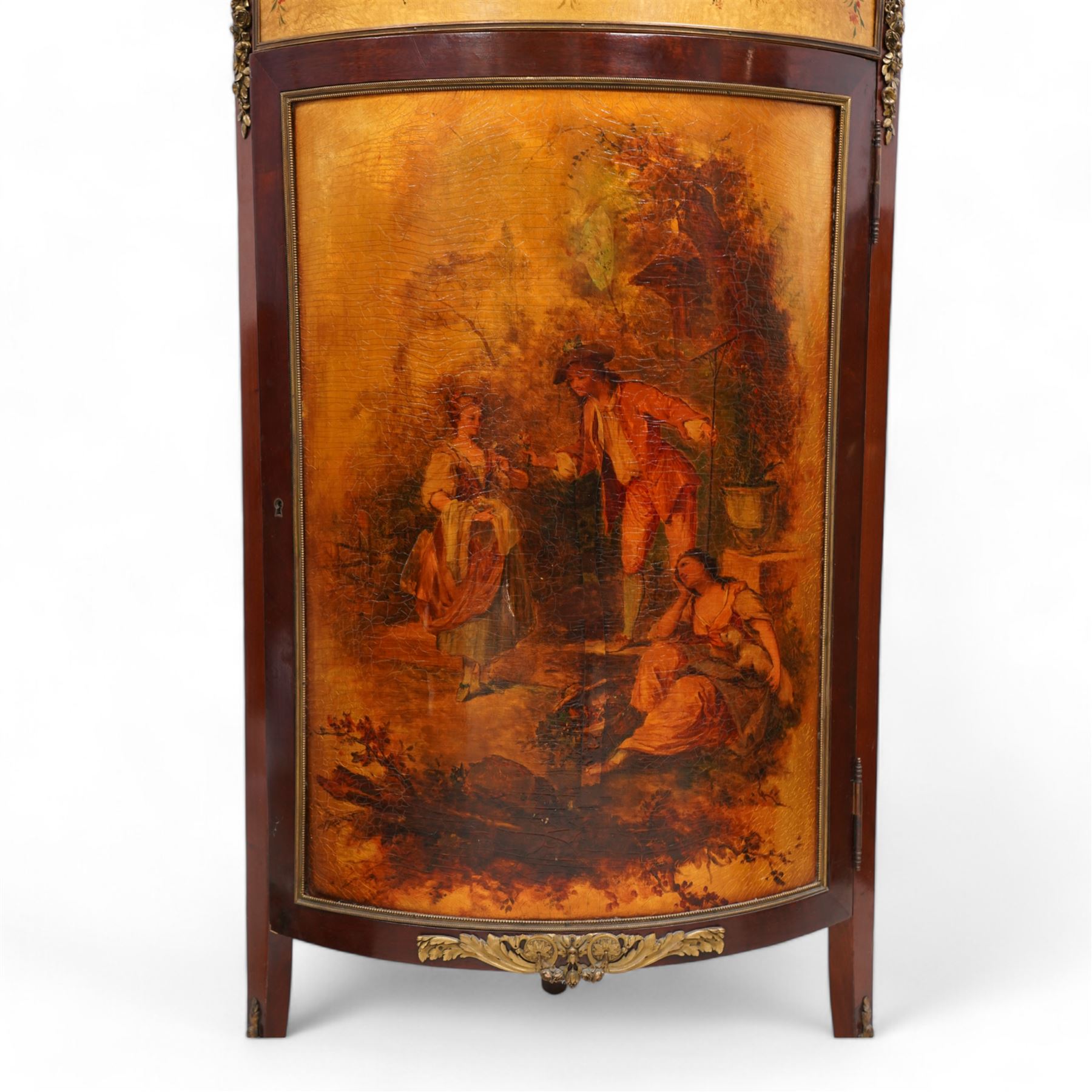 Mid-to-late 20th century mahogany and gilt metal mounted corner cupboard, raised back with floral decoration surmounted by laurel leaf wreath, single hinged drawer decorated with floral festoons, enclosed by single door with Vernis Martin design panel, on out splayed feet with foliate mounts 