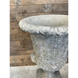 Pair of Georgian design cast stone garden urns, egg and dart rim with raised floral motifs, pedestal base terminating on square plinth, raised on square block plinth