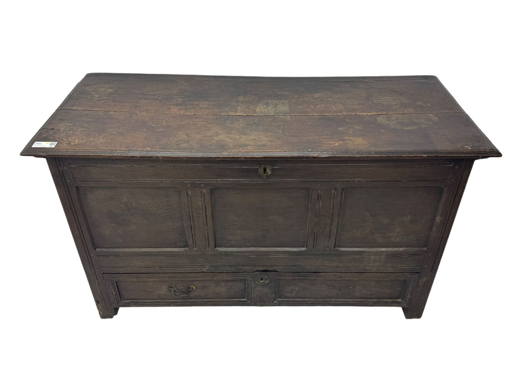 18th century oak mule chest, rectangular plank top with moulded edge, enclosing candle box with internal divisions, panelled front with applied moudlings, fitted with single drawer to the base with brass swing handle, on stile supports