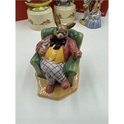 Two Royal Doulton Bunnykins music boxes, comprising Rocking Horse and Winter Waltz together with two Royal Doulton Bunnykins figures Once Upon a Time and Father, Mother & Victoria, all with original boxes  