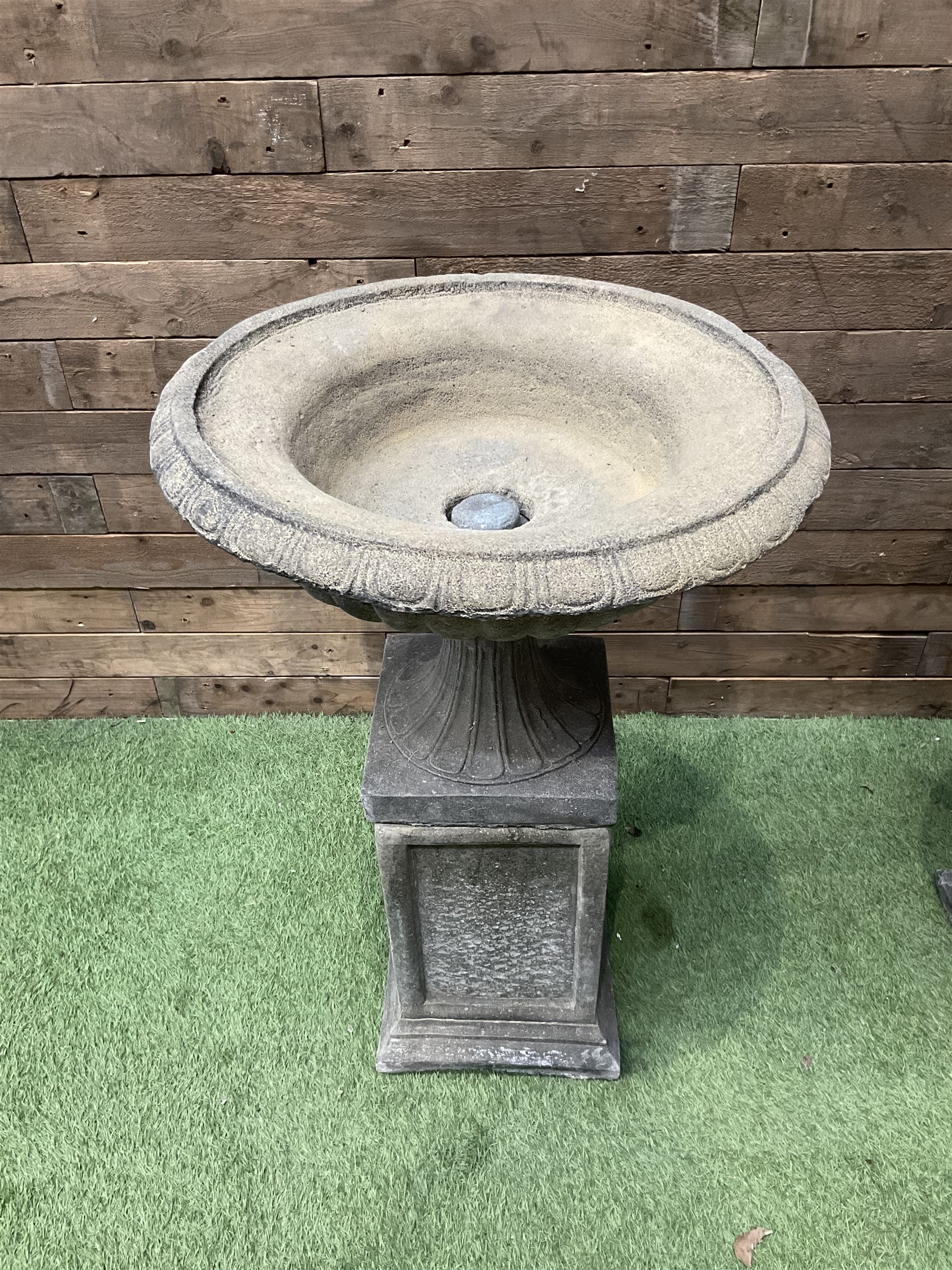 Pair of Victorian design cast stone squat garden urns, egg and dart border, raised on pedestal base and square fielded plinth - THIS LOT IS TO BE COLLECTED BY APPOINTMENT FROM DUGGLEBY STORAGE, GREAT HILL, EASTFIELD, SCARBOROUGH, YO11 3TX