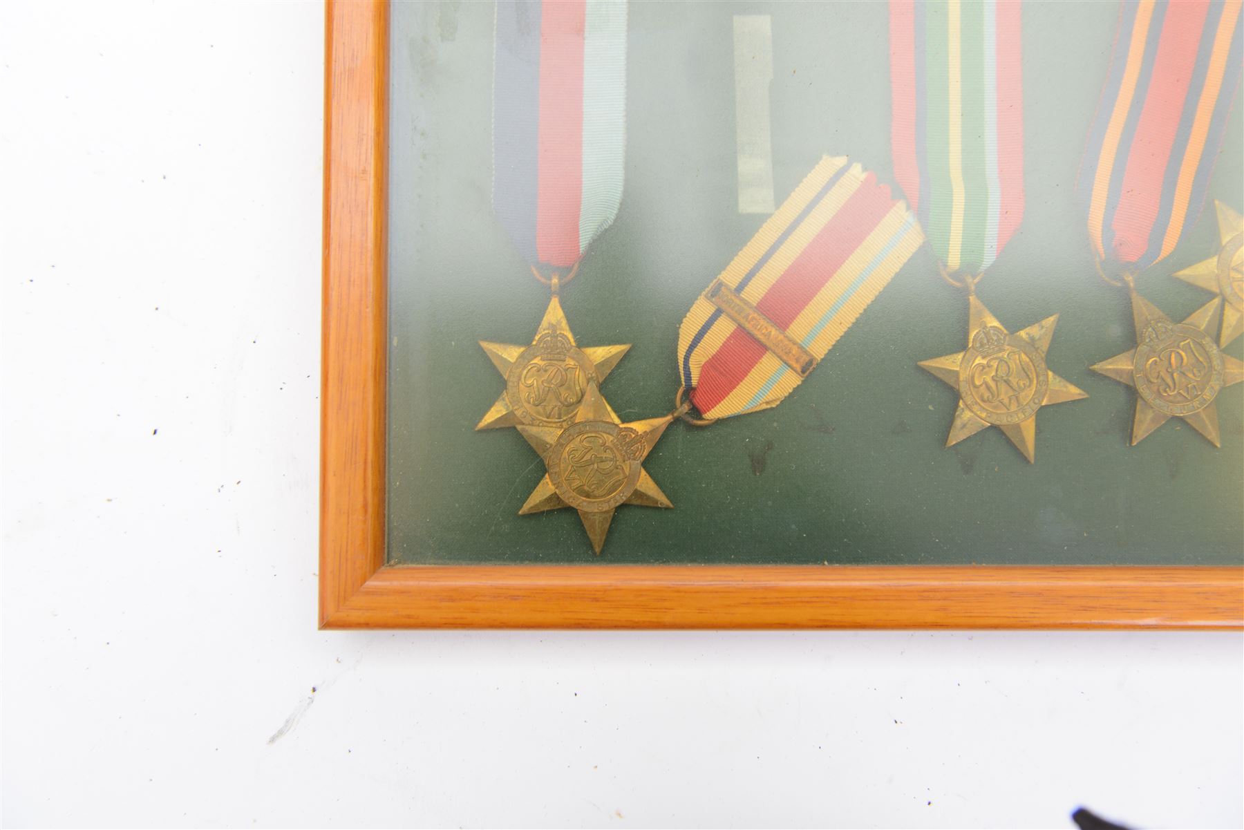 World War II medal group, comprising 1939-45 Star, Pacific Star, Burma Star, Italy Star, 
Atlantic Star, 1939-45 War medal and General Service medal, in glazed frame 