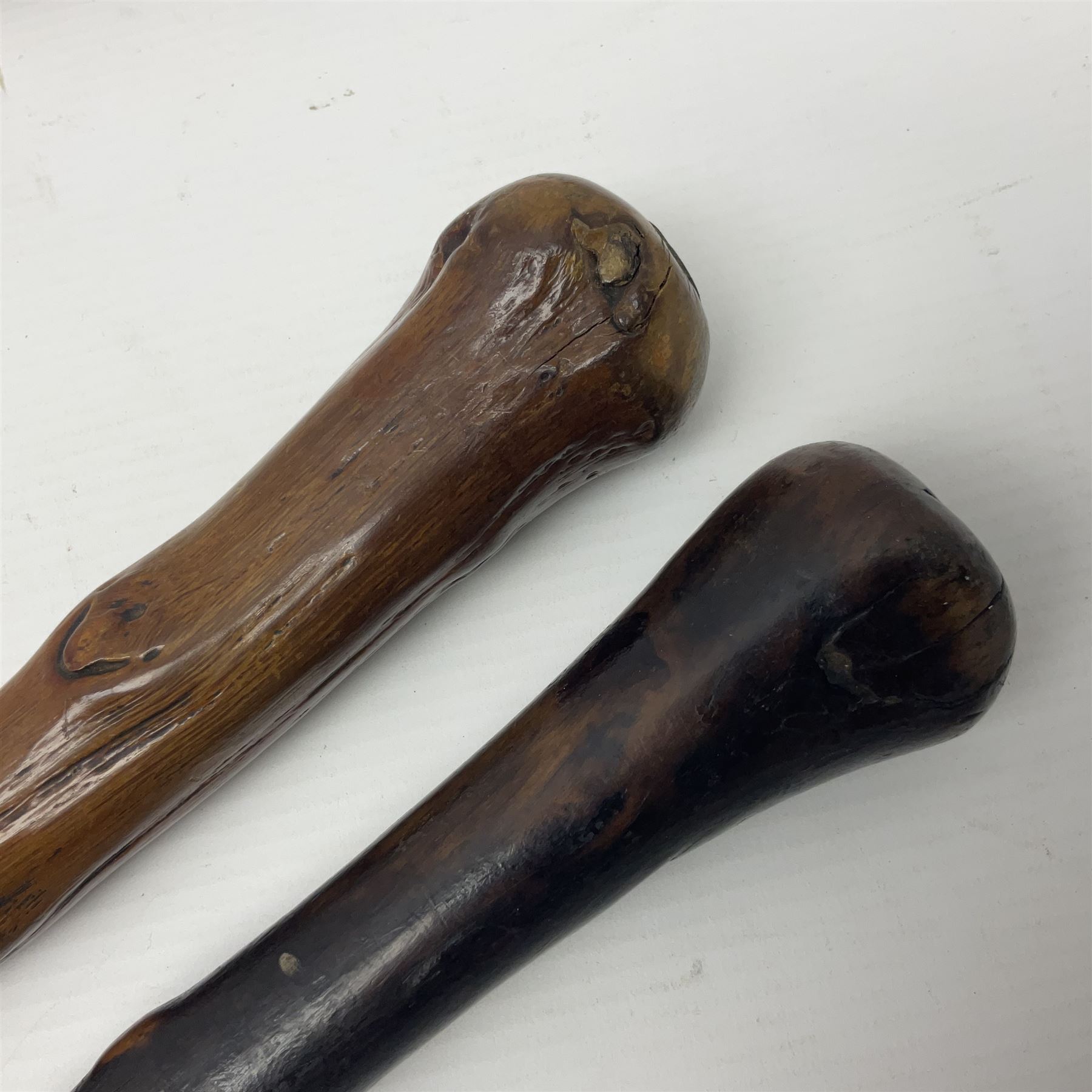 Two wooden walking sticks, both with comparts that would have housed horse measures, H88cm