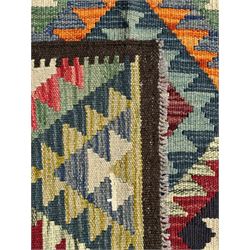 Maximana Kilim ground rug, the field decorated with a geometric pattern of multi-coloured diamonds and triangles, each containing stylised motifs, enclosed by a plain brown border