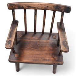 Vernacular 'Irish famine' or 'primitive' pine chair, bar cresting rail over spindle back, flat arms on thick plank seat, rounded supports 