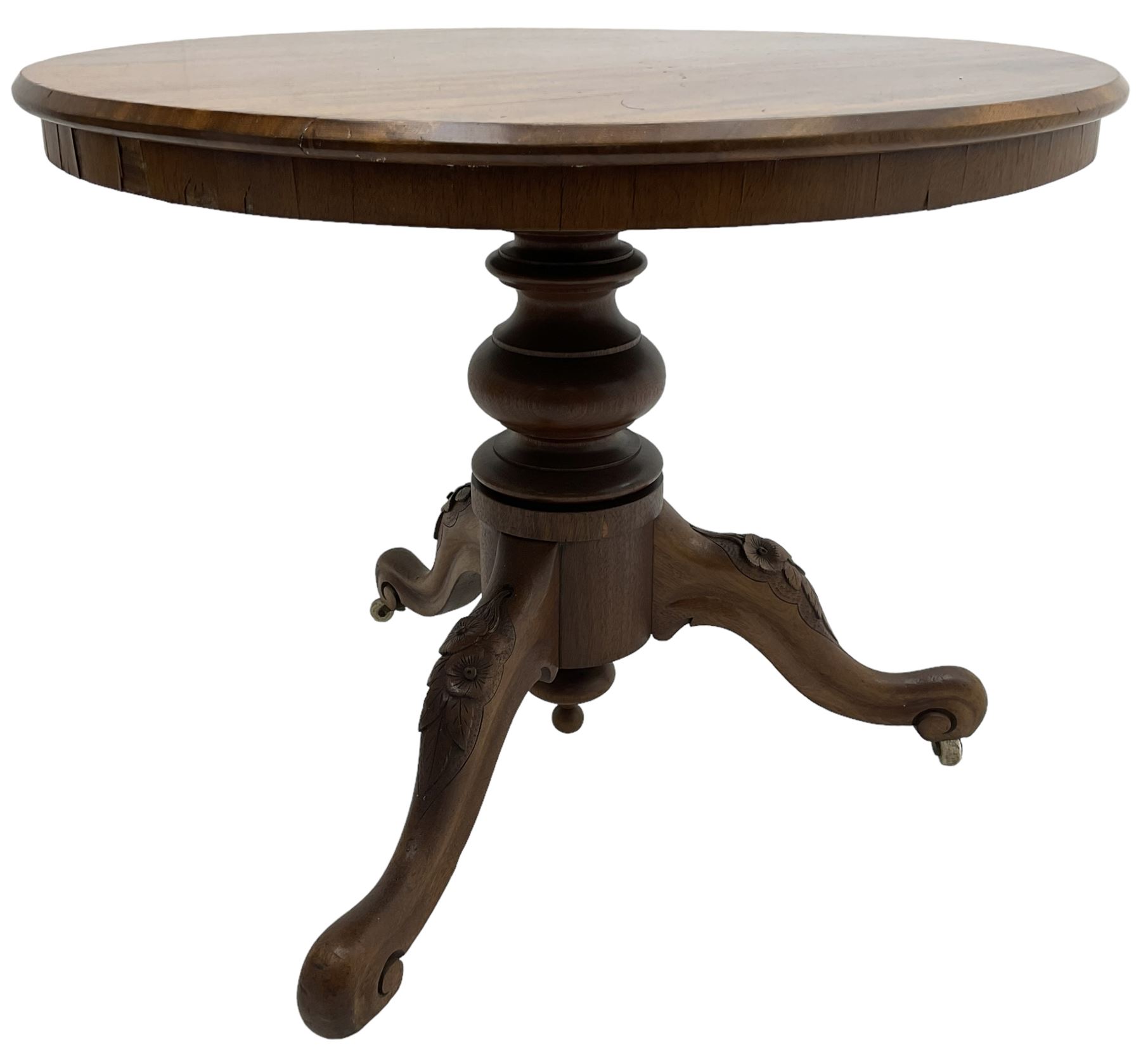 Victorian mahogany centre table, circular top on turned pedestal, on three flower head carved supports with scrolled terminals