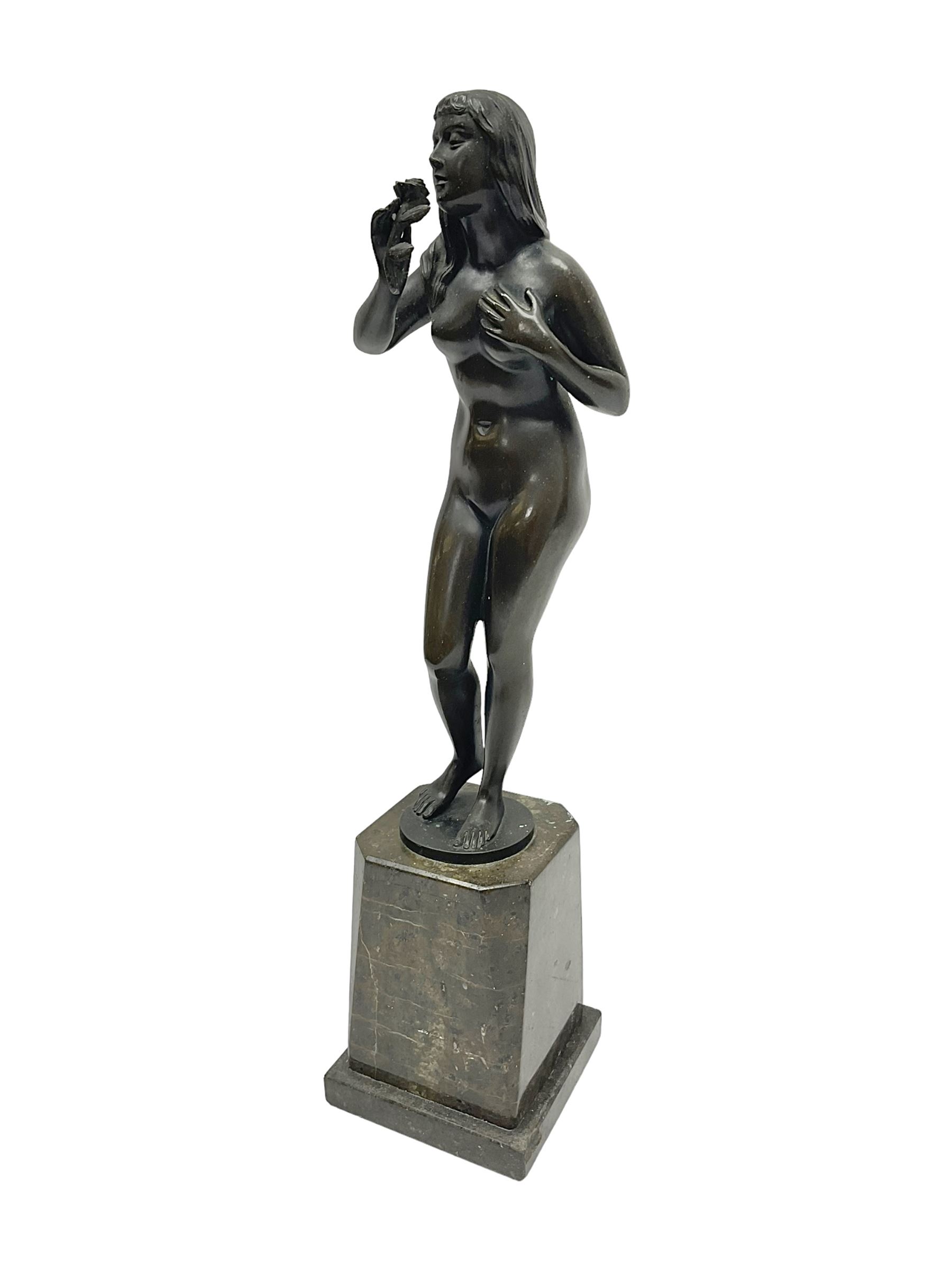 Bronze nude female figure holding a rose, upon a stone plinth, H40cm 