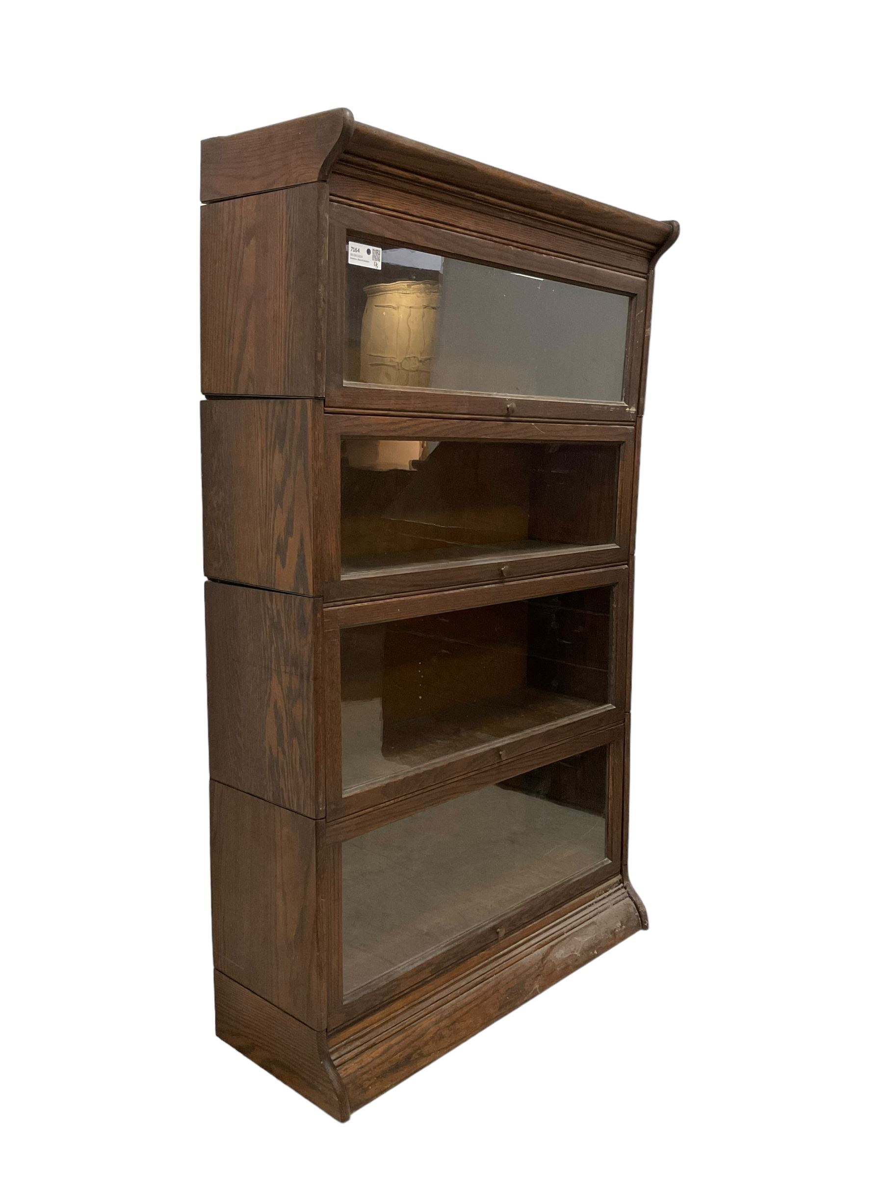 Early 20th century oak Globe Wernicke design sectional library bookcase, four sections each with hinged sliding glazed door, on moulded base 