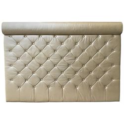 Large padded headboard, upholstered in beige buttoned faux leather