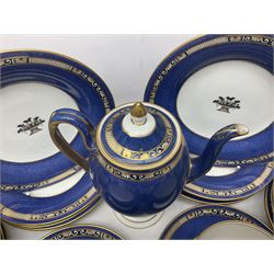 Wedgwood part tea and coffee service, comprising coffee pot, six coffee cans with five saucers, seven teacups with ten saucers and seven side plates, each decorated with floral bouquet to centre, in a gilt and speckled blue border, pattern x9933, with printed mark beneath