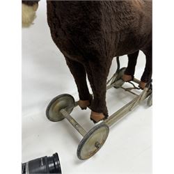 1920s/30s Panurge Pets push-a-long horse, with brown mohair body and white face, horse hair mane and tail and leather hooves, mounted upon a metal with rubber and metal wheels, including handle H71cm