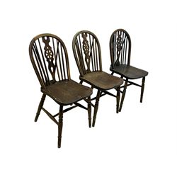 Mid-to-late 20th century set of six elm and beech Windsor dining chairs, hoop and stick back with pierced wheel splat, dished elm seat, on turned supports united by turned stretchers 